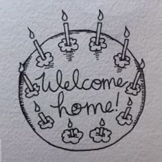 a birthday cake with candles and the words welcome home written on it in black ink