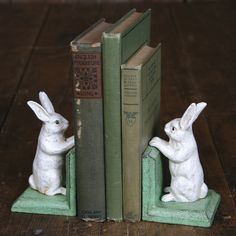 two bookends made to look like rabbits sitting next to each other