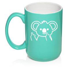 a teal colored mug with a koala face on it's left side