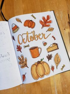 an open notebook with the words october written in orange and yellow on top of it