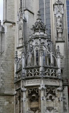 an old building with statues on the front