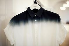 a black and white shirt is hanging on a hanger