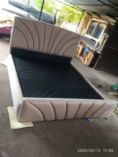 the bed is made up and ready to be put into its place in the garage