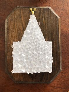 a piece of wood that has been made to look like a house with white frosting on it