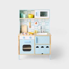 a toy kitchen with blue cabinets and white walls