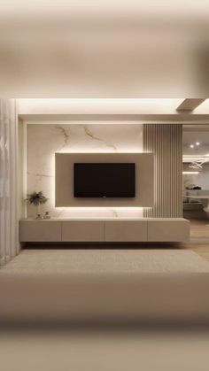 a living room with a large tv mounted to the side of it's wall