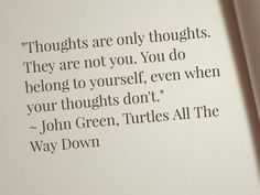 an open book with a quote from john green