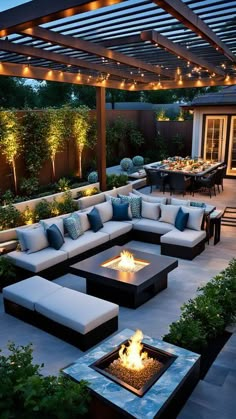 an outdoor living area with couches and fire pit