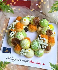 decorated cookies are arranged in the shape of a wreath on top of a greeting card