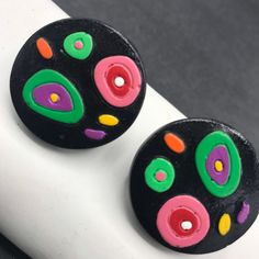 ON SALE Vintage colorful green pink black painted wooden pierced earrings in very good vintage condition. One and a quarter inches round. Very nice color combination perfect for any retro outfit. Retro Multicolor Clip-on Earrings, Vintage Multicolor Round Clip-on Earrings, Retro Multicolor Hand Painted Earrings, Retro Hand Painted Multicolor Earrings, Retro Black Round Earrings, Retro Outfit, Desert Hot Springs, Lucite Jewelry, Costume Jewelry Sets