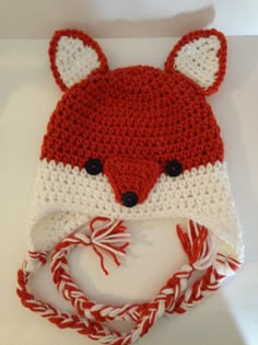 a red and white knitted hat with a fox face