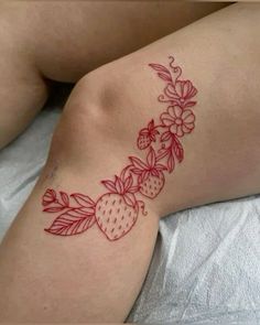 a woman laying on top of a bed covered in tattoos