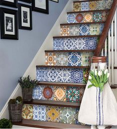 the stairs are decorated with colorful tiles and tulips in front of pictures on the wall