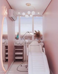 a room with a couch, desk and large window overlooking the city in pink hues