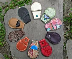 several pairs of mittens laid out in a circle on top of a stone slab