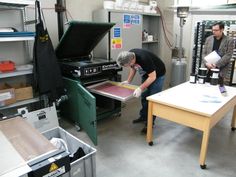 two men are working in a large factory