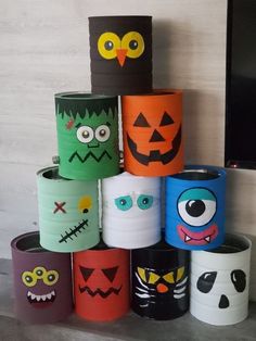 a stack of toilet paper rolls decorated to look like halloween faces and monsters with eyes