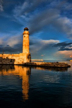 a light house sitting on top of a body of water