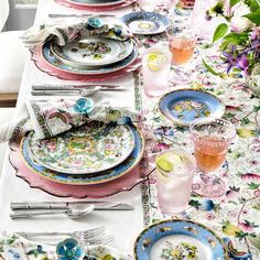 the table is set with colorful plates and silverware