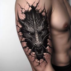 a man's arm with a black and grey tattoo on it, showing the head of a dragon