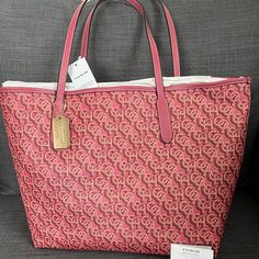 Brand New With Tag Coach Signature Tote Handbag Purse Grain Leather Rouge (Pink) Color Polished Gold Hardware Coach Logo & Medallion On The Front Snap Closure On The Top Interior: One Zip Pocket Approximately 13”-17”L X 11.5”H X 6"W Durable & Roomy Smoke & Pet Free Home Retail Price $398+Tax Please See My Entire Collection . Large Capacity Monogram Canvas Bag, Monogram Canvas Shopping Bag, Tan Monogram Canvas Bag For Shopping, Tan Monogram Canvas Shopping Bag, Monogram Canvas Shopping Bag With Branded Hardware, Luxury Pink Coated Canvas Bag, Pink Coated Canvas Top Handle Bag, Pink Top Handle Bag In Coated Canvas, Pink Coated Canvas Top Handle Shoulder Bag