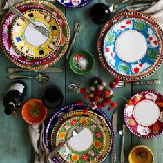 the table is set with colorful plates and utensils