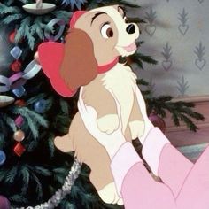 lady and the tramp sitting in front of a christmas tree with ornaments on it