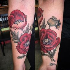 two red flowers are on the arm and one is in full bloom, while the other has