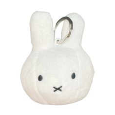 a white stuffed animal keychain with a bunny face on it's side