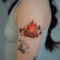 a woman with a tattoo on her arm that has a fire in the middle of it