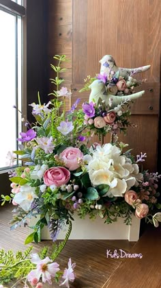 an arrangement of flowers in a vase on a table