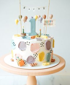 a colorful birthday cake with candles and decorations