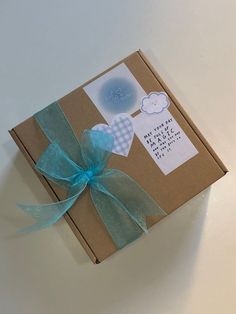 an open box with a blue bow on it