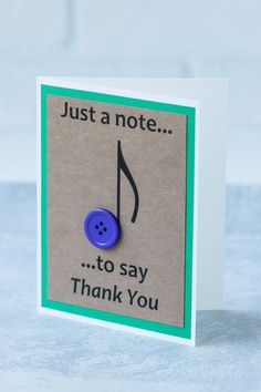 a note with a blue button on it that says, just a note to say thank you