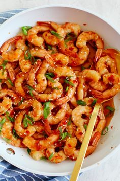 a white bowl filled with shrimp and sauce