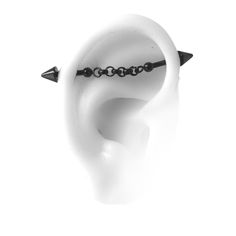 an ear with black beads on it and two spikes sticking out of the middle of it