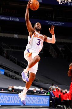 a basketball player jumping up to dunk the ball