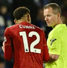 two soccer players standing next to each other