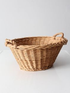 a wicker basket sitting on top of a white table