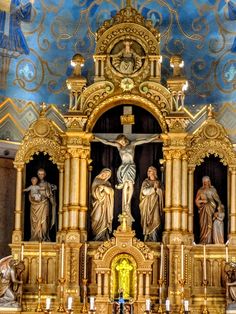 an ornate alter in a church with statues on it