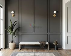 a living room with gray walls and wooden floors, large plant in vases on the far wall