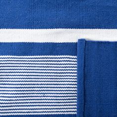 a blue and white striped towel folded on top of each other, with the bottom half showing