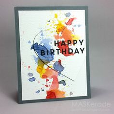 a happy birthday card with watercolor paint splattered on the front and back