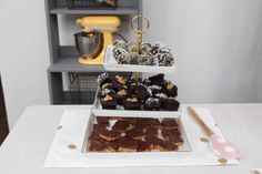 three tiered trays filled with pastries on top of a table