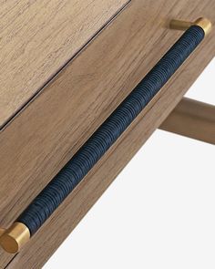 a close up of a wooden drawer with metal handles