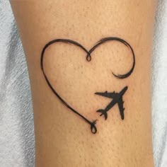 an airplane is in the shape of a heart tattoo on someone's leg,