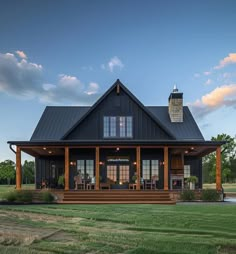 a large black house with porch and covered patio