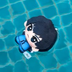 an overhead view of a toy boy swimming in a pool