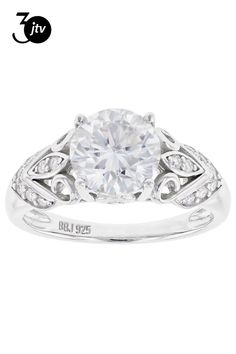 a white gold ring with diamonds on the band and a center stone in the middle