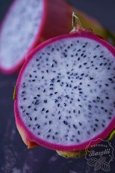 the fruit is cut in half and ready to be eaten with its seeds still attached